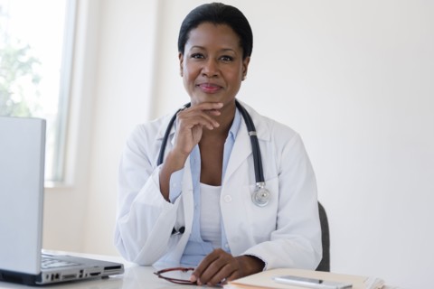 Black doctor sitting at desk
