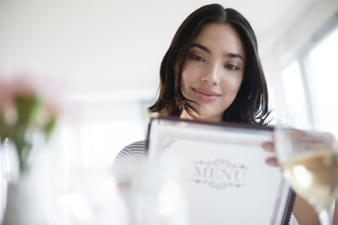 Hispanic woman reading menu
