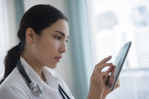 Hispanic doctor using digital tablet