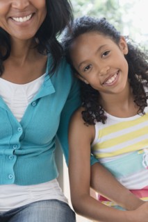 Mother and daughter smiling