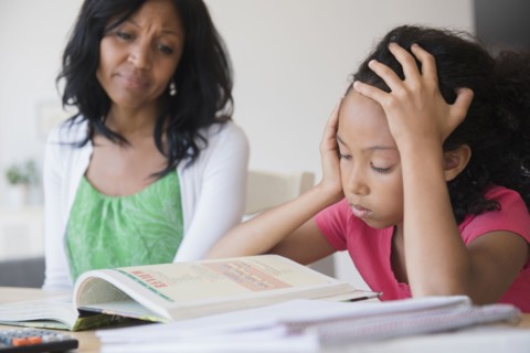 Mother helping daughter with homework