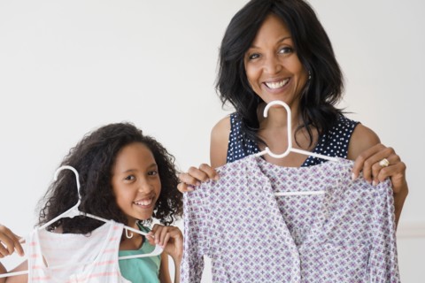 Mother and daughter displaying clothing