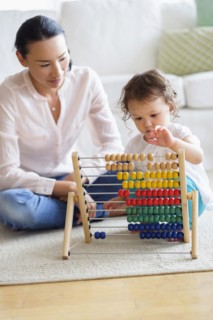 Mother and baby girl playing with abacus