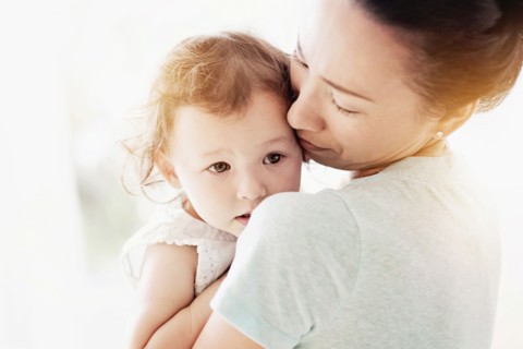 Mother holding baby daughter