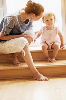 Mother and baby daughter sitting on steps
