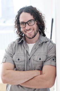 Caucasian man smiling with arms crossed