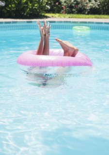 Caucasian woman playing in swimming pool
