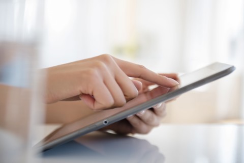 Hispanic woman using digital tablet