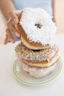 Hispanic woman choosing donut