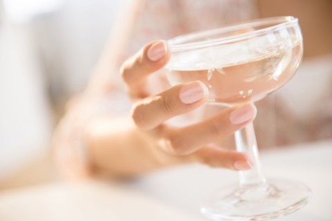 Hispanic woman drinking cocktail