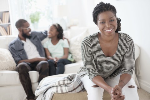 Black mother sitting in living room
