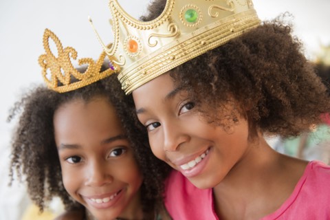 Mixed race sisters playing dress up