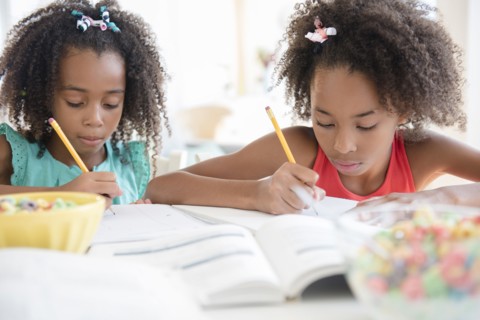 Mixed race sisters doing homework