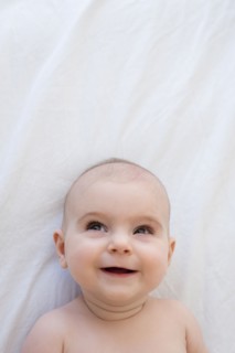 Caucasian baby girl laying on blanket