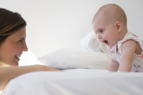 Caucasian mother and baby daughter playing