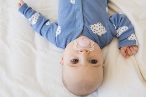 Caucasian baby girl with pacifier