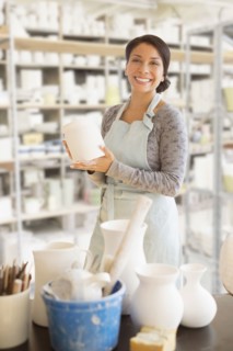 Mixed race potter smiling in workshop