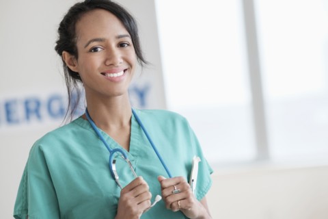 Mixed race nurse smiling in hospital