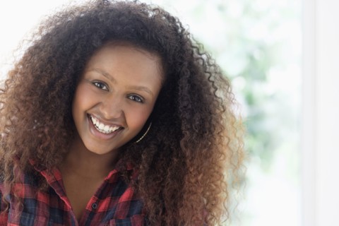 Black woman smiling indoors