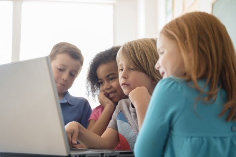 Students using laptop in classroom
