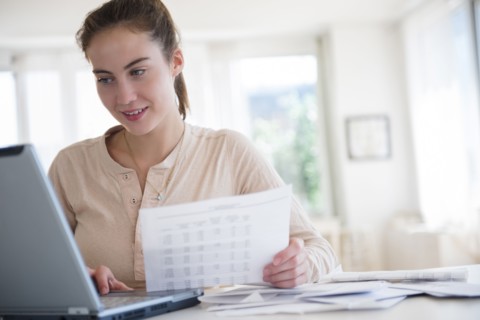 Native American woman paying bills on computer