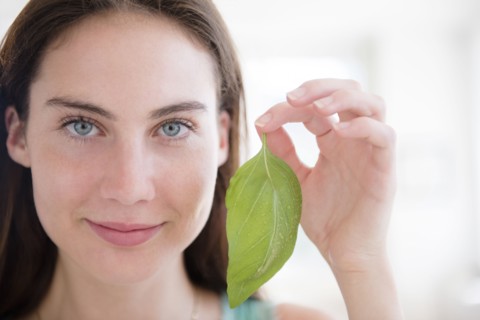 Native American woman holding leaf