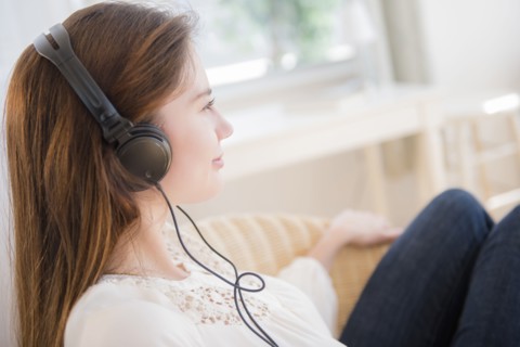 Native American woman listening to headphones
