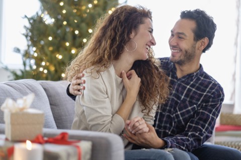 Couple hugging on sofa