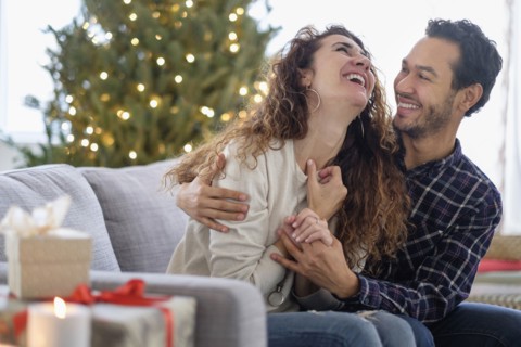 Couple hugging on sofa