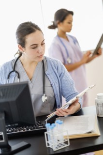 Nurse reading medical chart in hospital