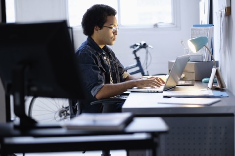 Mixed race businessman working in office