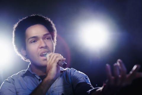 Mixed race singer performing on stage