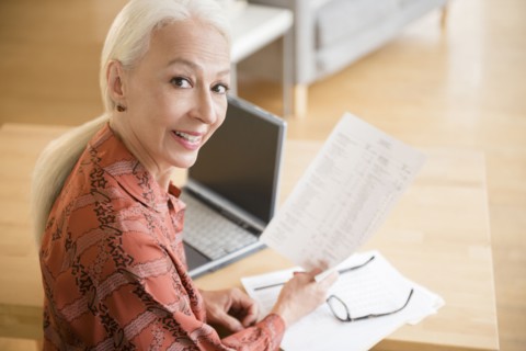 Caucasian woman paying bills on laptop