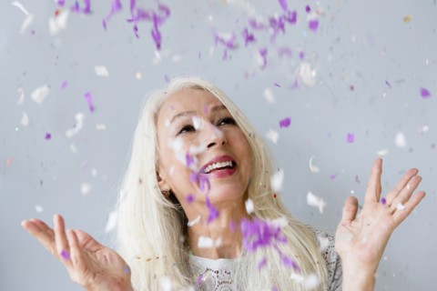 Caucasian woman throwing confetti