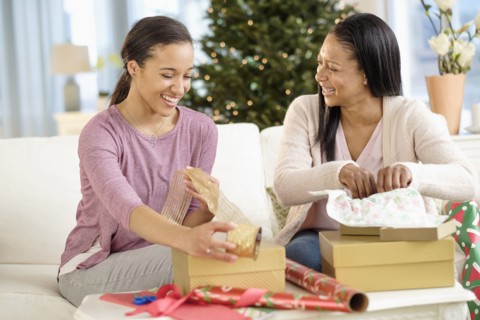 Mother and daughter wrapping Christmas gifts