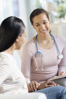 Doctor comforting patient in living room
