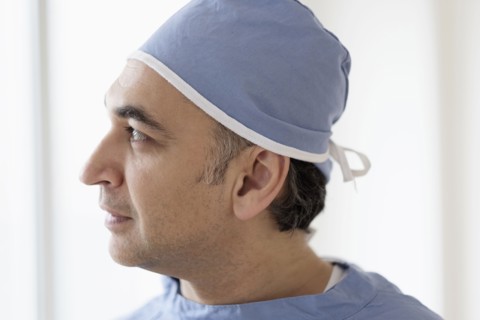 Mixed race surgeon wearing scrubs