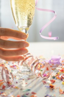 Hispanic woman holding glass of champagne