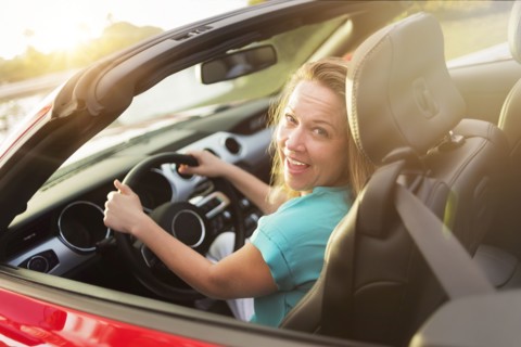 Caucasian woman driving convertible