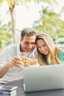 Caucasian couple video chatting on laptop outdoors