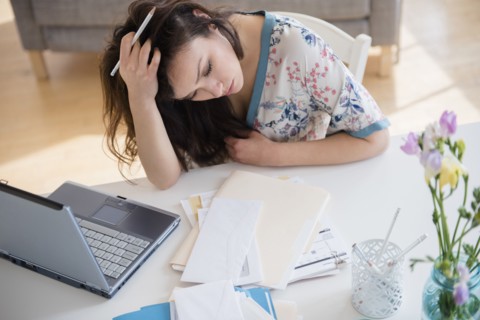 Stressed woman paying bills