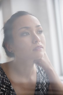 Tranquil woman looking out window