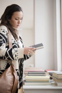 Woman shopping for books in bookstore