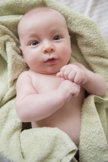 Caucasian baby wrapped in towel