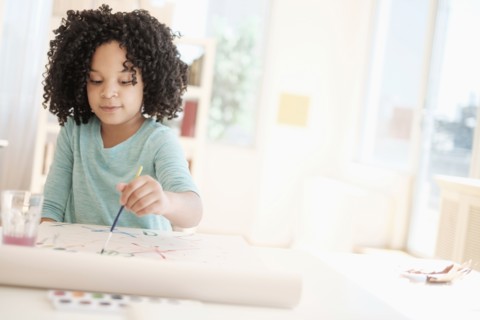 African American girl painting with watercolors
