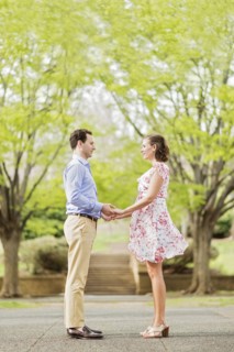 Pregnant Caucasian couple holding hands outdoors