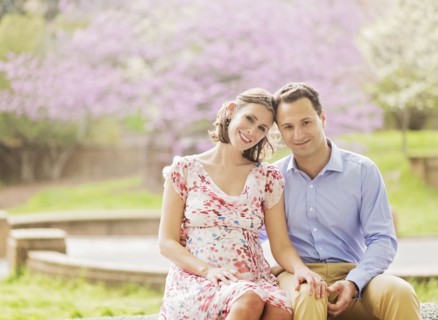 Pregnant Caucasian couple smiling outdoors