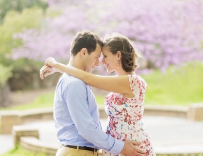 Pregnant Caucasian couple hugging outdoors