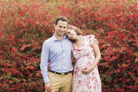 Pregnant Caucasian couple hugging outdoors