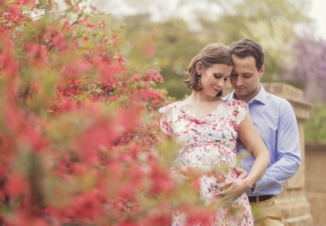 Pregnant Caucasian couple hugging outdoors